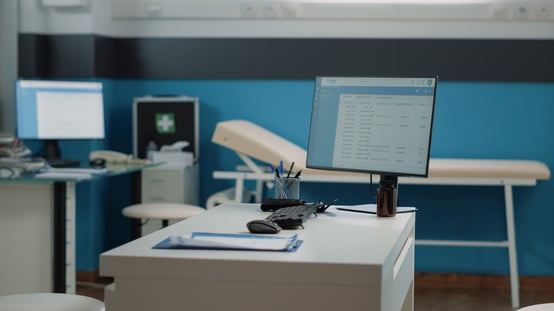empty-doctors-office-with-medical-equipment-for-healthcare-nobody-in-cabinet-with-tools-instruments-computer-and-checkup-documents-on-desk-workplace-for-doctor-at-facility